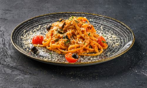 Pasta with tomato, parmesan cheece and olives